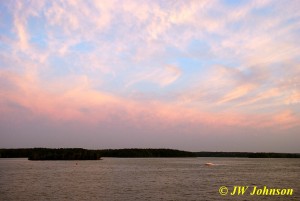 Speedboat Races Across Sunset Sky