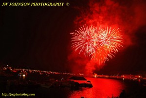 Bright Red Bursts Above Bay