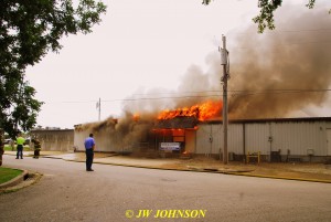 28 Heavy Fire Blows Out of Cason Realty Roof